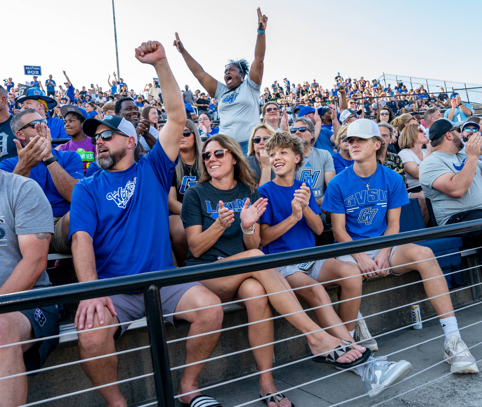 Undecided major Jack Veldhouse, right, watches a GVSU touchdown with family members (from left: parents Steve and Carmen Veldhouse and brother Max) as GVSU football hosts Davenport at Lubbers Stadium during Laker Family Weekend on October 4. (Photo rel...